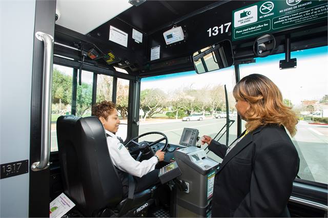 Passenger using Genfare's FastFare farebox to board bus